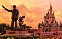 A statue of Walt Disney and Mickey Mouse, in front of Cinderella Castle at Magic Kingdom park