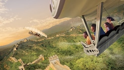 A family of Guests smiles while flying above the Great Wall of China during Soarin’ Around the World