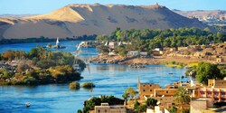 A waterway flows through a seaside village and mountainous desert region A waterway flows through a seaside village and mountainous desert region
