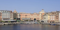 The exterior of the Tokyo DisneySea Hotel MiraCosta overlooking a waterfront area The exterior of the Tokyo DisneySea Hotel MiraCosta overlooking a waterfront area
