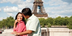 A couple gazes into each other’s eyes near the Eiffel Tower in Paris A couple gazes into each other’s eyes near the Eiffel Tower in Paris