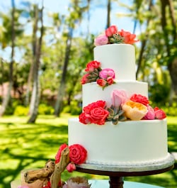 A wedding cake with Hawaiian roses at Aulani, a Disney Resort & Spa, in Kapolei, Hawaii