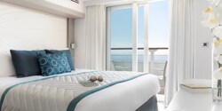 A grand deluxe suite, featuring a bed and window A grand deluxe suite, featuring a bed and window