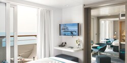 An owner's suite, featuring a bed, window, desk, and TV An owner's suite, featuring a bed, window, desk, and TV