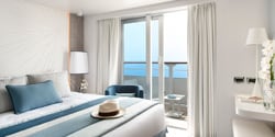 A prestige suite, featuring a bed and window A prestige suite, featuring a bed and window