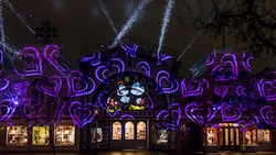 Hearts and an image of Mickey Mouse and Minnie Mouse, projected onto Crystal Arcade