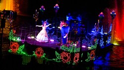 The beauty, Belle, and the Beast dance on a romantic, rose-decorated Fantasmic! float