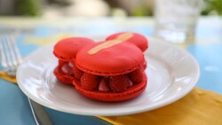 Mickey shaped raspberry macaron on a plate