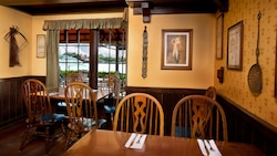 Two corner tables near walls lined with English memorabilia