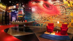 Illustration of Figment, a purple dragon character, posing similar to the Mona Lisa painting