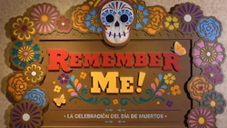 A sign that reads Remember Me La Celebracion Del Dia De Muertos