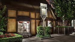 Exterior of The Tea Caddy shop in the United Kingdom Pavilion at night