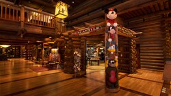 A totem pole of Disney characters at the entrance of Wilderness Lodge Mercantile