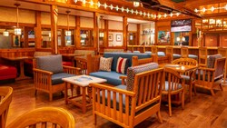 Tables and chairs next to a bar at Disney's Beach Club Resort