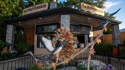 La Poutinerie food booth at Epcot with Canadian themed decor