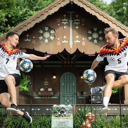 A soccer duo freestyling with soccer balls near the Germany Gazebo at Epcot