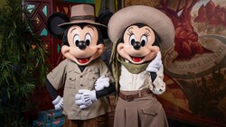 Mickey Mouse and Minnie Mouse standing arm in arm at Discovery Island