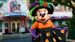 Minnie Mouse wearing a Halloween outfit in front of Hollywood & Vine restaurant