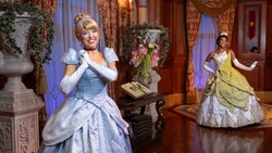 Cinderella and Tiana, posing in their tiaras inside Princess    Fairytale Hall