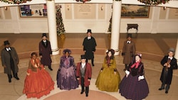 A cast of Dickens carolers gathered for Epcot’s Festival of Holidays at The American Adventure Pavilion