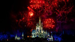 Fireworks bursting above Cinderella Castle at night