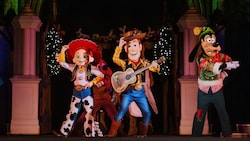 Jessie, Woody and Goofy perform on stage at Mickey’s Most Merriest Celebration