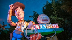 The entrance to Toy Story Land in Disney's Hollywood Studios theme park, featuring oversized toys and a giant Woody statue