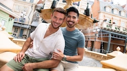 A couple poses for a photo at a fountain in the Italy Pavilion at EPCOT