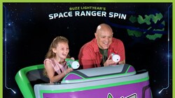 A father and daughter riding Buzz Lightyear’s Space Ranger Spin