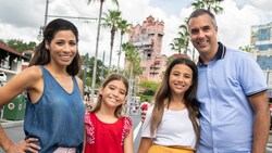 Two parents and their 2 daughters pose for a photo on Sunset Boulevard