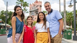 Two parents and their 2 daughters pose for a photo on Sunset Boulevard