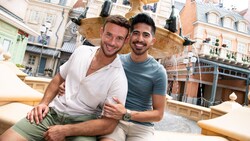 A couple poses for a photo at a fountain in the Italy Pavilion at EPCOT
