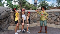 A Disney Magic Shot, featuring Princess Tiana from ‘The Princess and the Frog’ with 3 young Guests at Tiana’s Bayou Adventure at Walt Disney World Resort