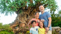A family of 4 in front of the Tree of Life at Disney’s Animal Kingdom theme park