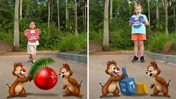 A Disney PhotoPass Magic Shot featuring 2 surprised young Guests holding Mickey Mouse shaped holiday greeting signs and watching Chip and Dale play with Christmas and Hanukkah ornaments