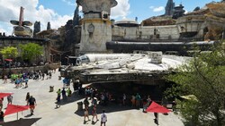 People gather around the Millennium Falcon at Batuu