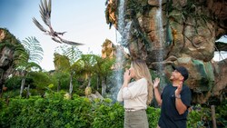 A Disney Magic Shot, featuring a banshee flying above a couple visiting Pandora, the World of Avatar, at Disney’s Animal Kingdom theme park