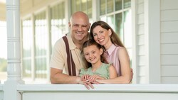 A family of 3 posing for a photo during a portrait session at Walt Disney World Resort