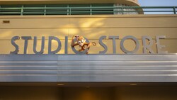 The Disney Studio Store sign featuring Abu the monkey above a metal awning