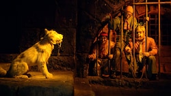 Three pirates in a jail cell trying to lure a dog with a key at Pirates of the Caribbean