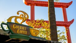 Artistic outdoor signage in the shape of a coffee cup for the Cappuccino Cart serving gourmet coffee by Joffreys Coffee and Tea Company, located in San Fransokyo Square at Disney California Adventure Park