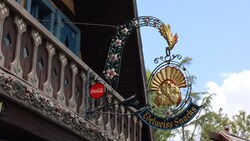 The ornate Edelweiss Snacks sign outside a Bavarian style building at Disneyland park