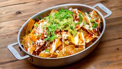 A pan with handles filled with Baked Nachos from GCH Craftsman Grill
