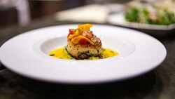 A Sautéed Diver Scallop with cherry tomatoes, tangerine and basil
