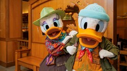 Daisy Duck and Donald Duck posing in outdoor adventure clothing at Storytellers Cafe