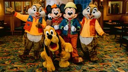 Chip ‘n’ Dale, Mickey Mouse, Minnie Mouse and Pluto posing in fall clothing at Storytellers Cafe