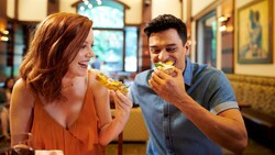 A couple enjoying a bite to eat during the Disney California Adventure Food and Wine Festival at the Disneyland Resort.
