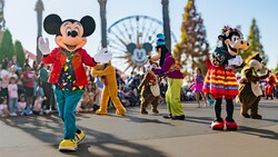 Mickey Mouse leading Pluto, Goofy, Chip and Dale during a holiday parade