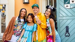 2 young men and 2 young women posing for a photo together near the entrance to Tiana’s Palace restaurant