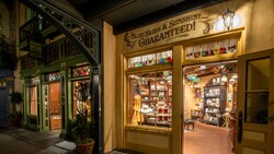 The facade of a New Orleans themed shop with the words 'Blue Skies & Sunshine Guaranteed' on the wall